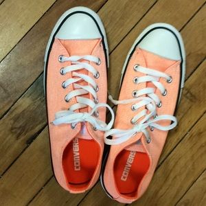Converse neon orange shoes.